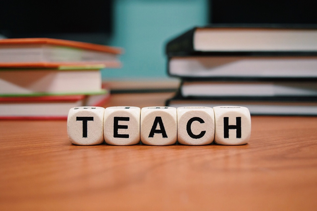 Blocks on a desk that spell the word teach